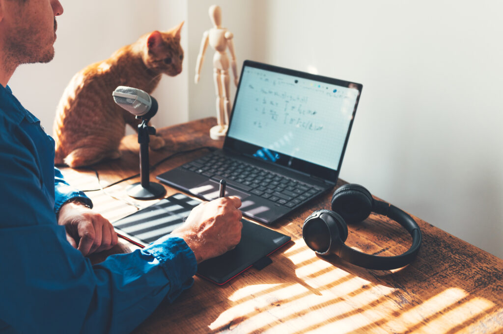 a-male-professor-uses-a-touchpad-and-laptop-on-top-of-a-table-to-utilize-the-EquatIO-Chrome-extension-for-his-virtual-classes