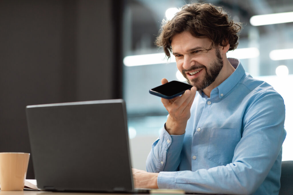 a-male-professor-using-the-VoiceIn-Chrome-extension-on-his-cellphone-and-laptop-to-record-audio-tasks