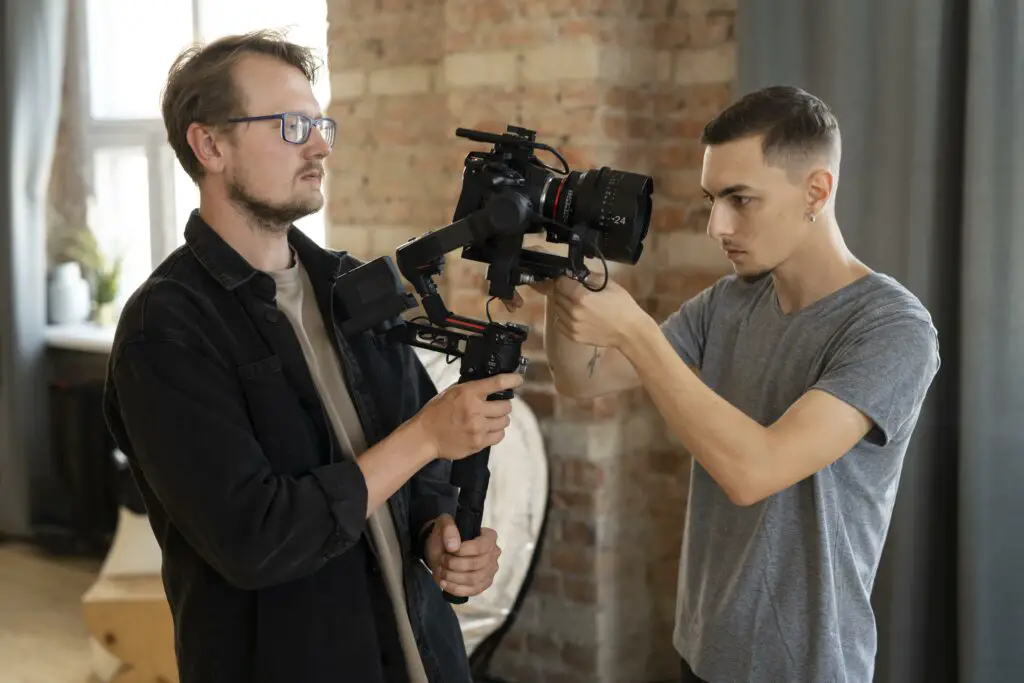 Film students adjusting the video camera on set
