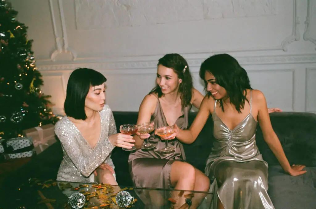 female-college-students-sitting-and-cheering-drinks-at-a-roaring-twenties-party