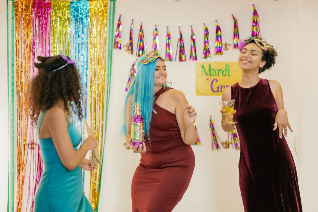 three-female-college-students-dancing-at-a-mardi-gras-college-party