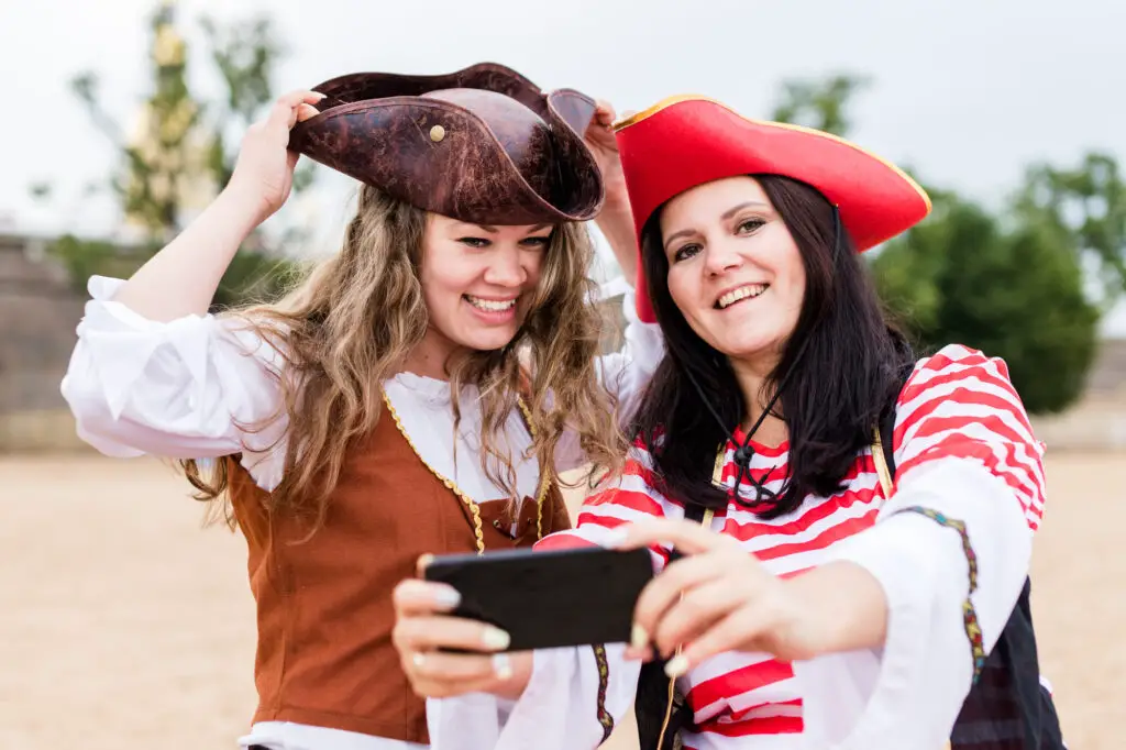 female-students-taking-a-selfie-and-wearing-pirate-makeup-and-costumes-for-a-college-party