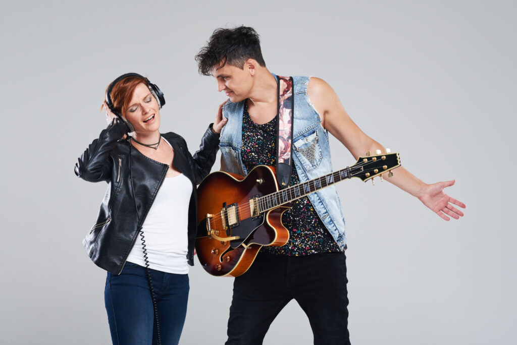 male-and-female-college-students-wearing-rockstar-makeup-and-costume-with-guitar-for-a-rock-n-roll-college-party