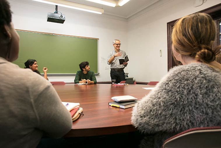 A professor discussing lessons in a small classroom at Sarah Lawrence College