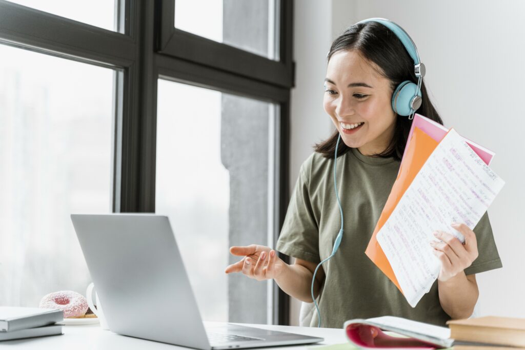 A female college student attending online class showing her finished essay as part of the non-traditional grading system requirement