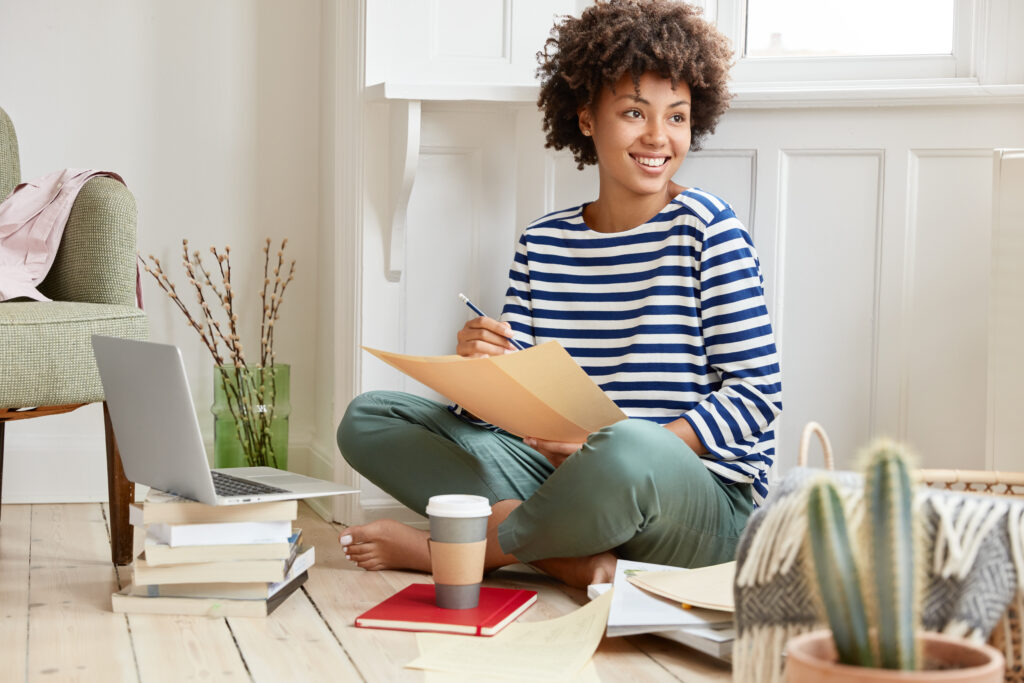 College student writing a reflective essay as part of her portfolio for submission under a non-traditional grading system