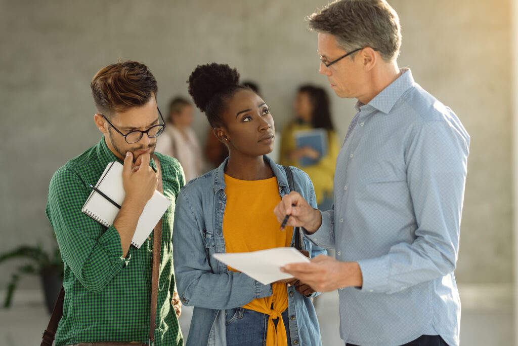 Professor and students discussing how to do a self-evaluation in an alternative grading system