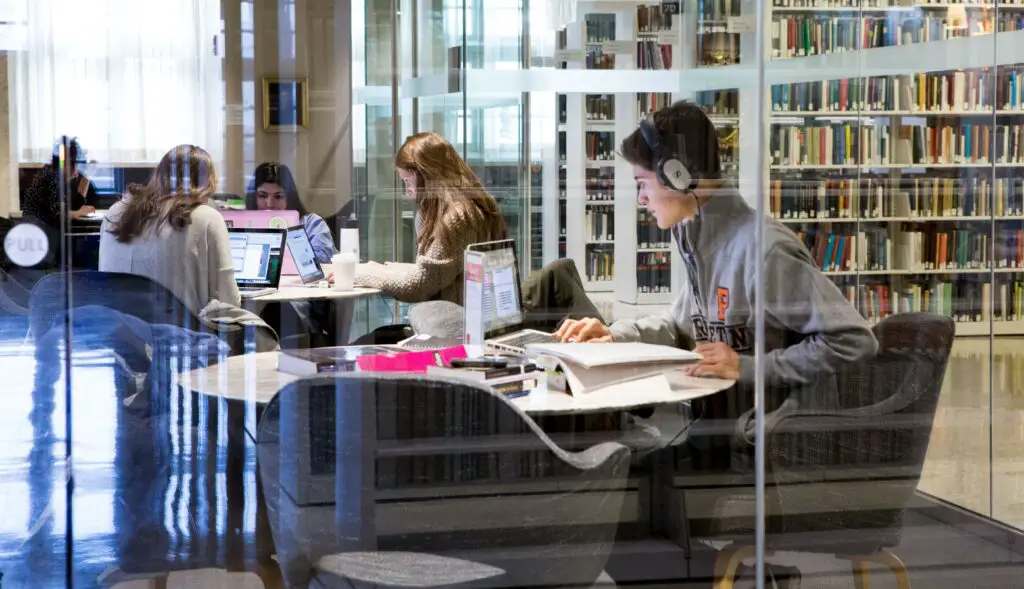 Princeton University student studying in the library along with four other students
