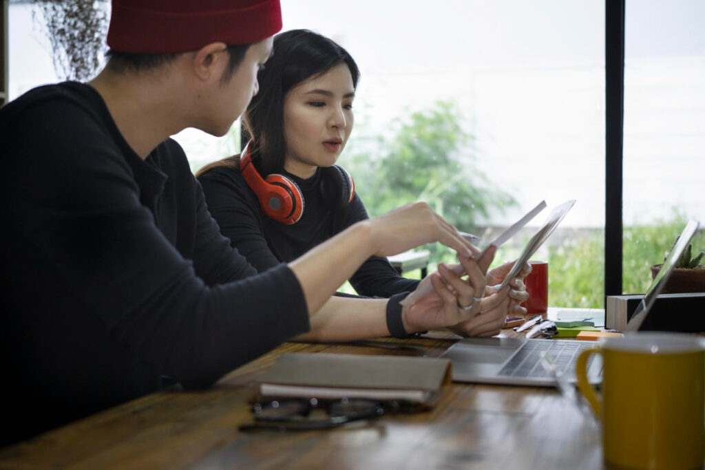 Two computer science students discussing their project for Stanford's app development class