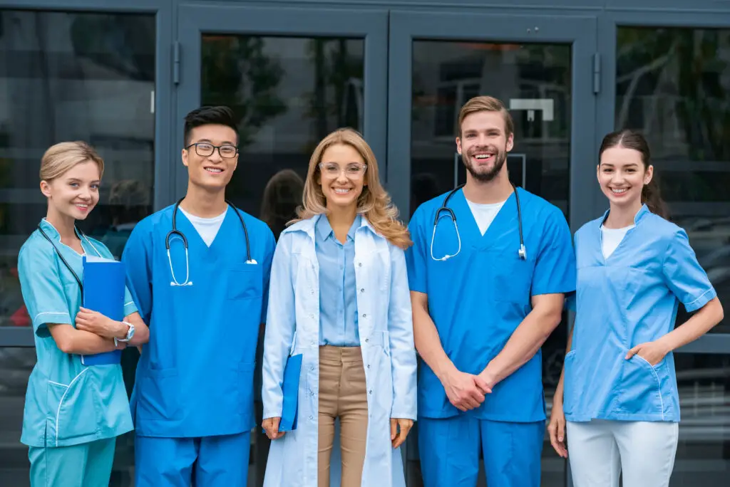 male-and-female-medical-students-wearing-blue-scrubs-and-stethoscope-smile-for-the-camera