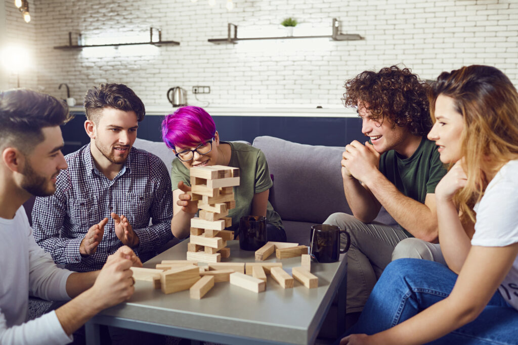 male-and-female-college-students-playing-jenga-from-their-college-packing-checklist