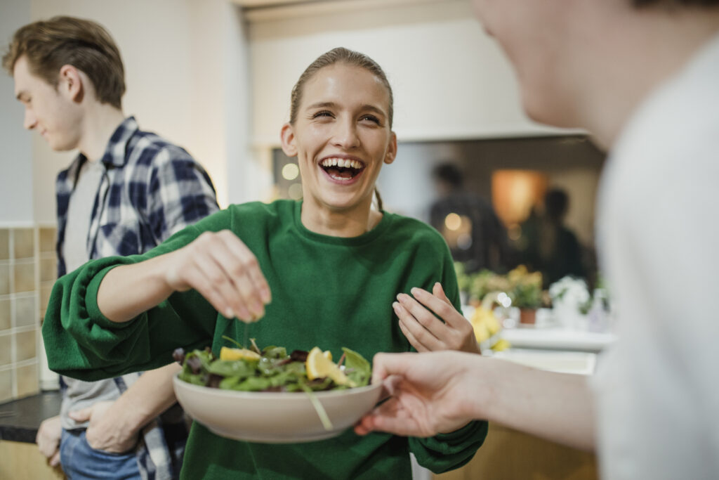 male-and-female-college-students-enjoying-food-and-using-kitchen-items-from-their-college-packing-checklist