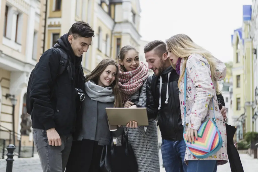 A group of European college students from the Worms University of Applied Sciences, one of the weirdest college names worldwide, checking a tablet for class updates 