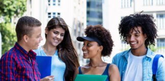 a diverse group of male and female international college students studying outdoors