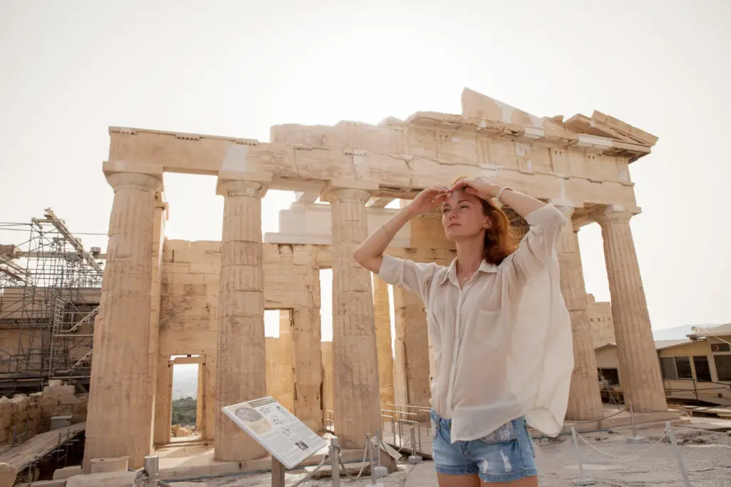 A female college student visiting the Acropolis as part of her cheap travel destinations
