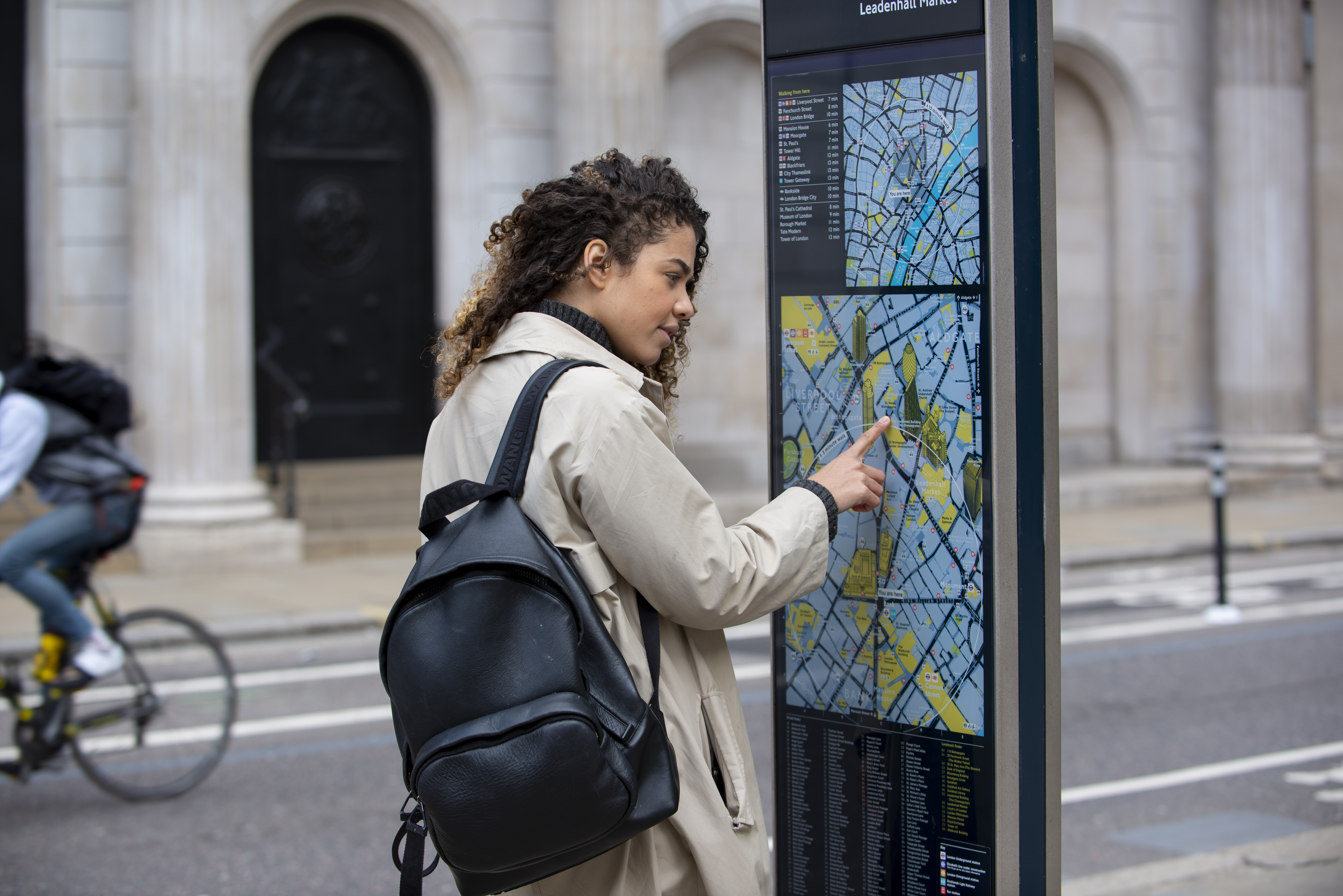 A female college student checking a European city's public transportation map