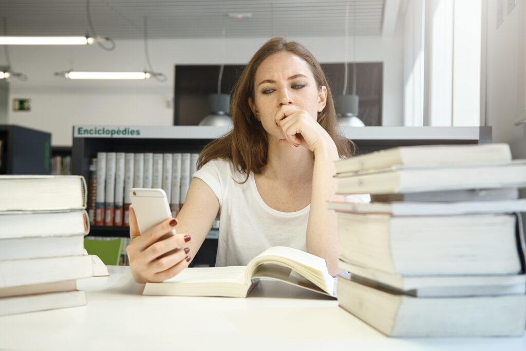 A disappointed female college student decides not to hassle herself with all the log in details to access unnecessary social media notifications while studying