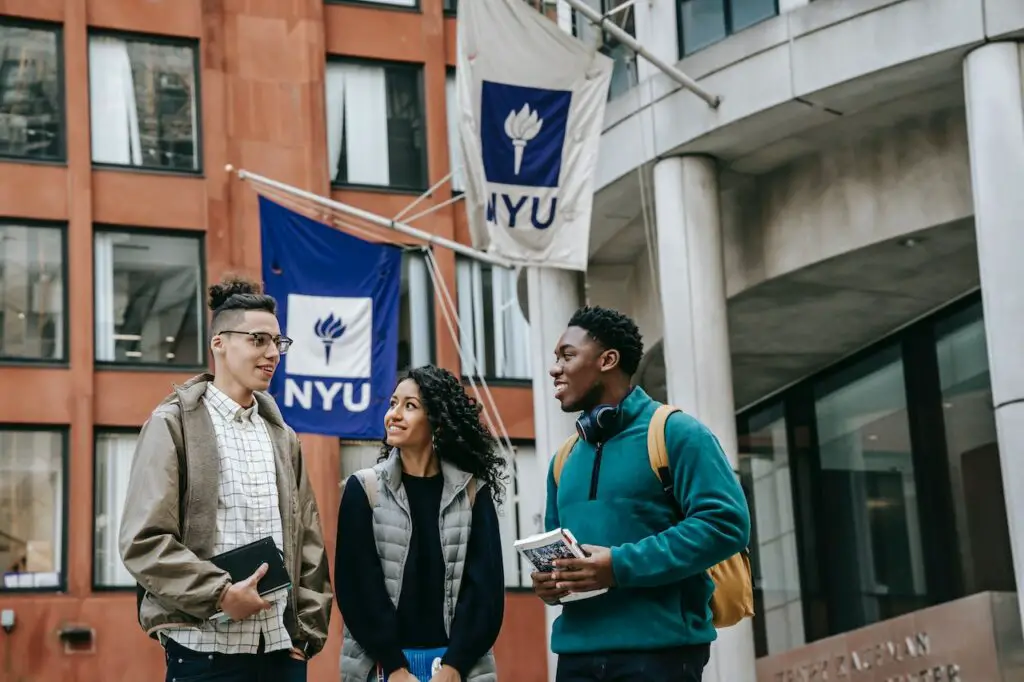 three-multi-ethnic-college-students-standing-near-nyu-building
