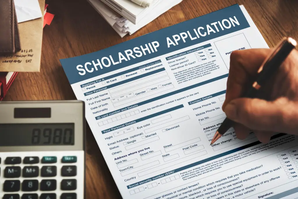 close-up-of-hand-filling-up-scholarship-application-form