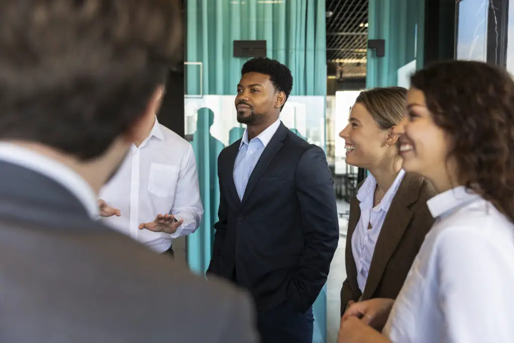 A group of smartly-dressed happy college students joins a career networking event