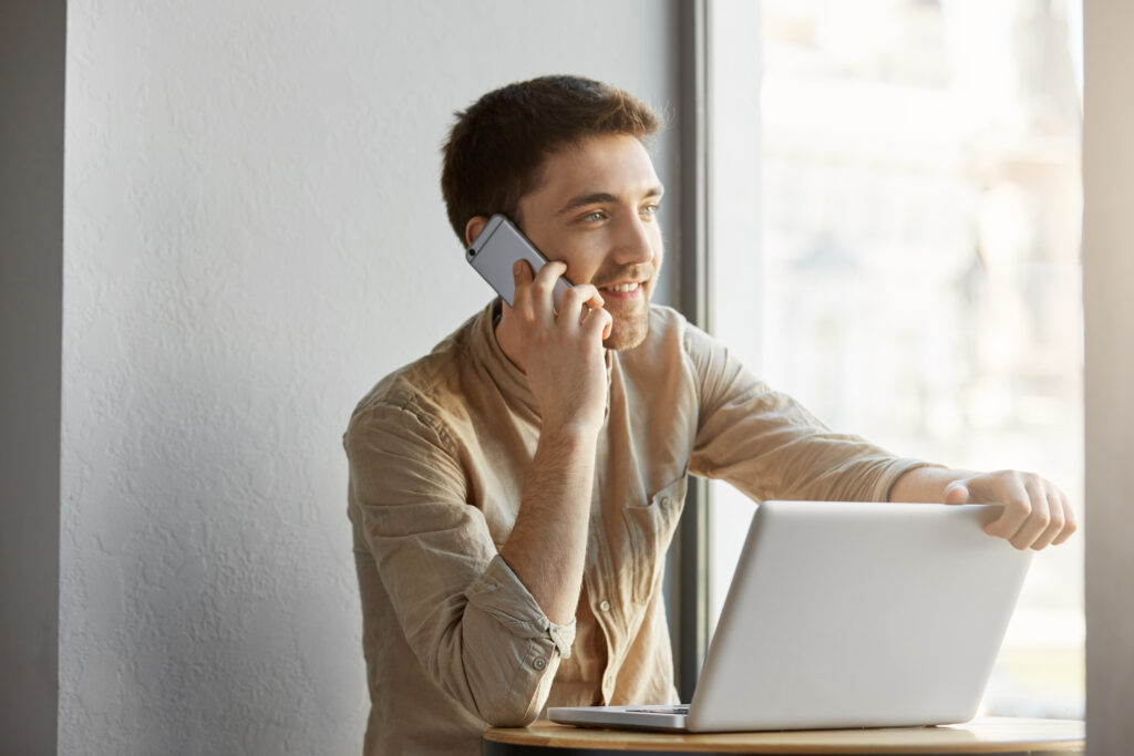 A male Caucasian college student calls the financial aid office of his university for updates on scholarship programs and renewals