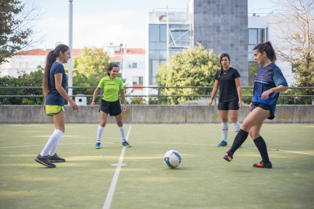 A group of four female high school soccer players thinking about how to find scholarships for college based on their athletic merits