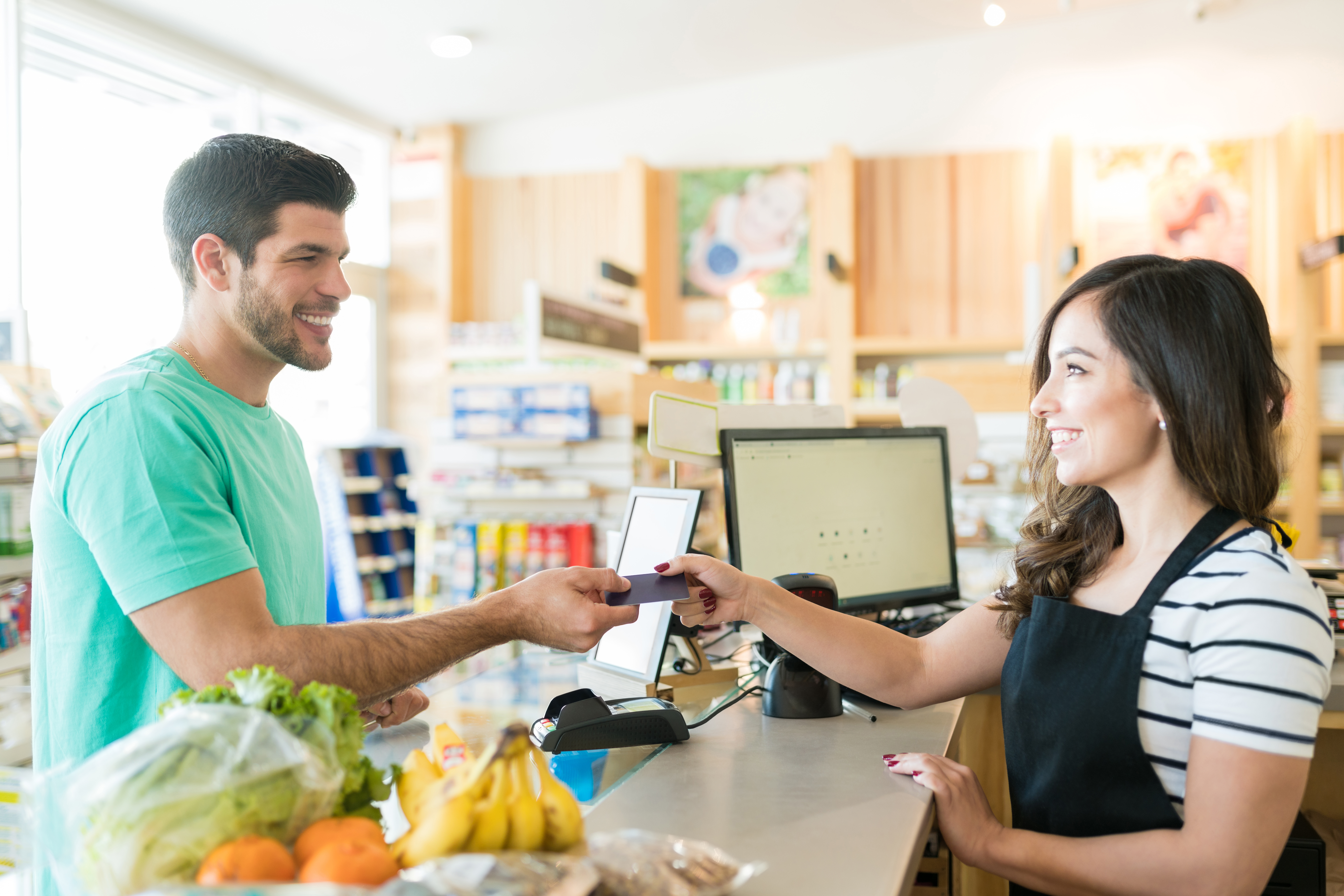 A female college student working as a part-time cashier ensures giving great customer service to strengthen her case in asking her employer for tuition assistance or a scholarship 