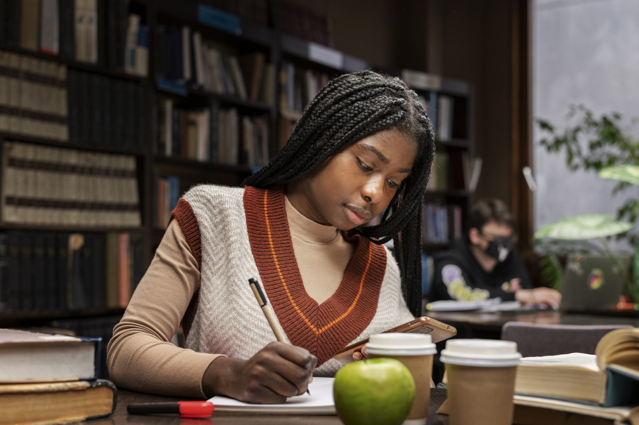 An African-American female college student studying in the campus library