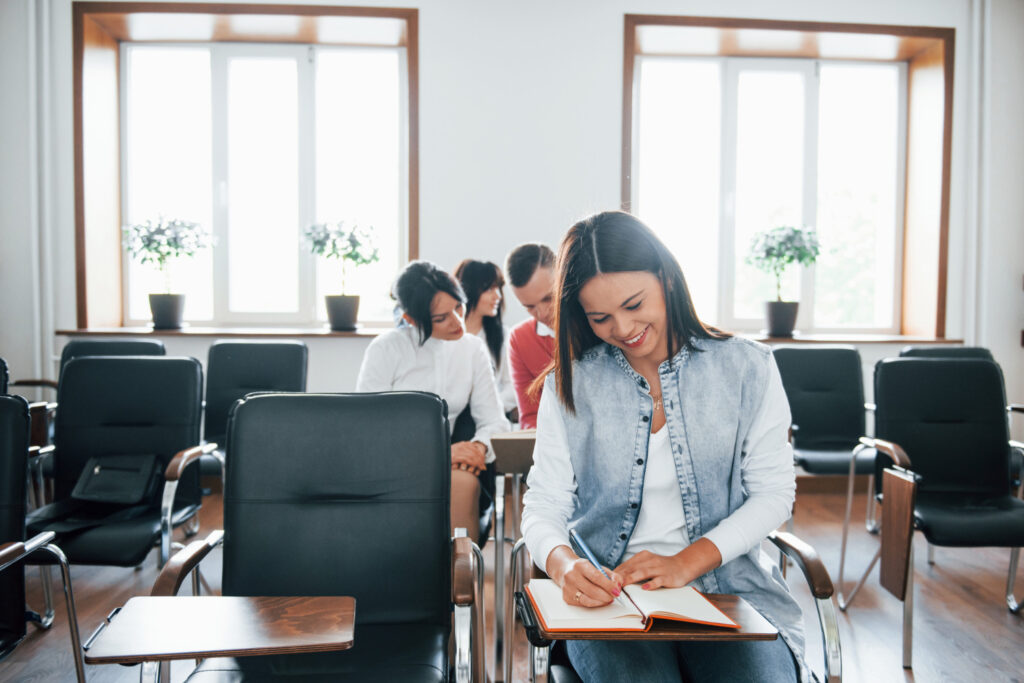 a female and a group of college students studying in an inexpensive public college