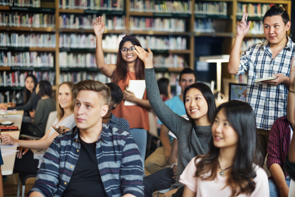 A group of college students having a discussion inside a classroom