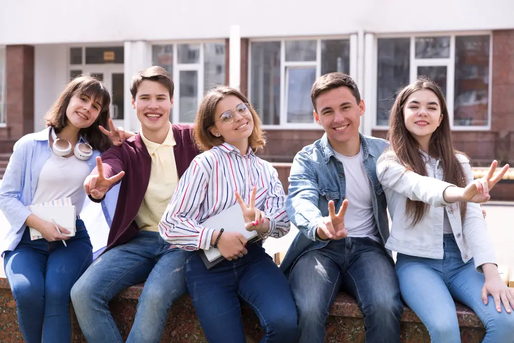 A diverse group of five college students happily hanging out with each other after studying for pre-law classes