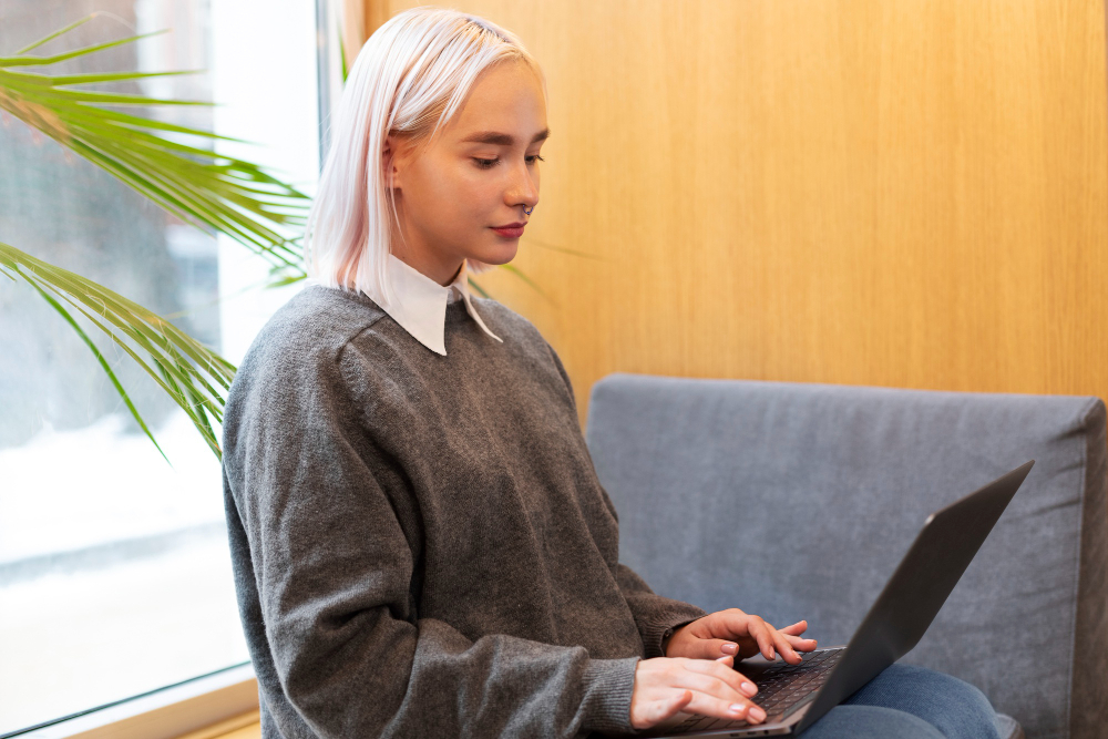 A female college student taking practice tests for law school on her laptop
