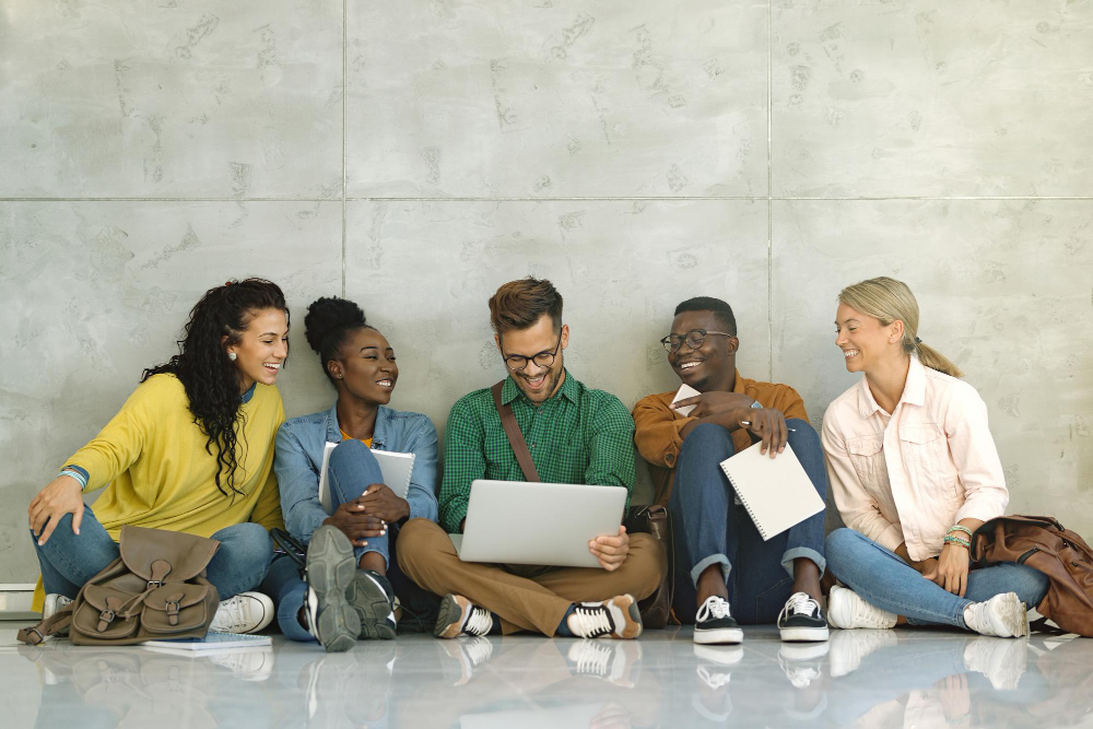 A diverse group of five pre-law college students happily hanging out in the campus lobby