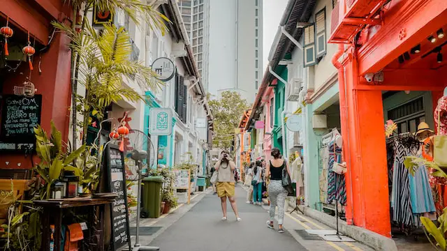 female-college-student-studying-abroad-taking-a-picture-in-the-middle-of-Haji-Lane-in-Singapore