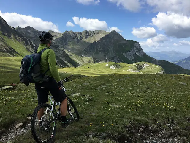male-college-student-riding-a-mountain-bike-in-Saint Antönien-Switzerland-and-earning-credits-overseas