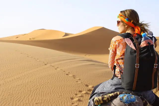 female-college-student-riding-a-horse-in-the-Sahara-desert-in-Morocco-completing-study-abroad-program