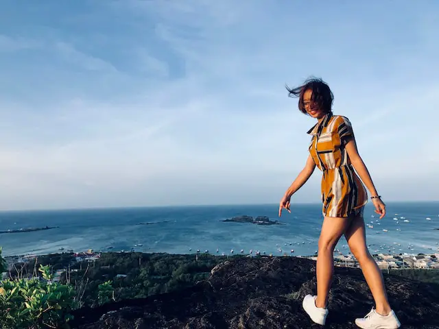 female-study-abroad-college-student-standing-on-top-of-an-oceanview-in-Vietnam