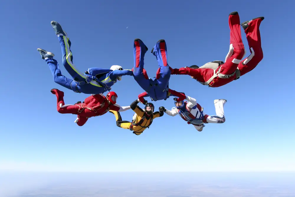 male and female college members of unusual student clubs in college go for a skydiving activity