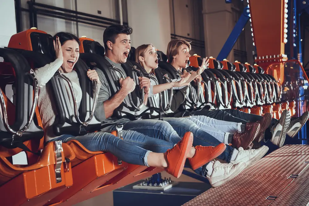male and female college students at a theme park ride