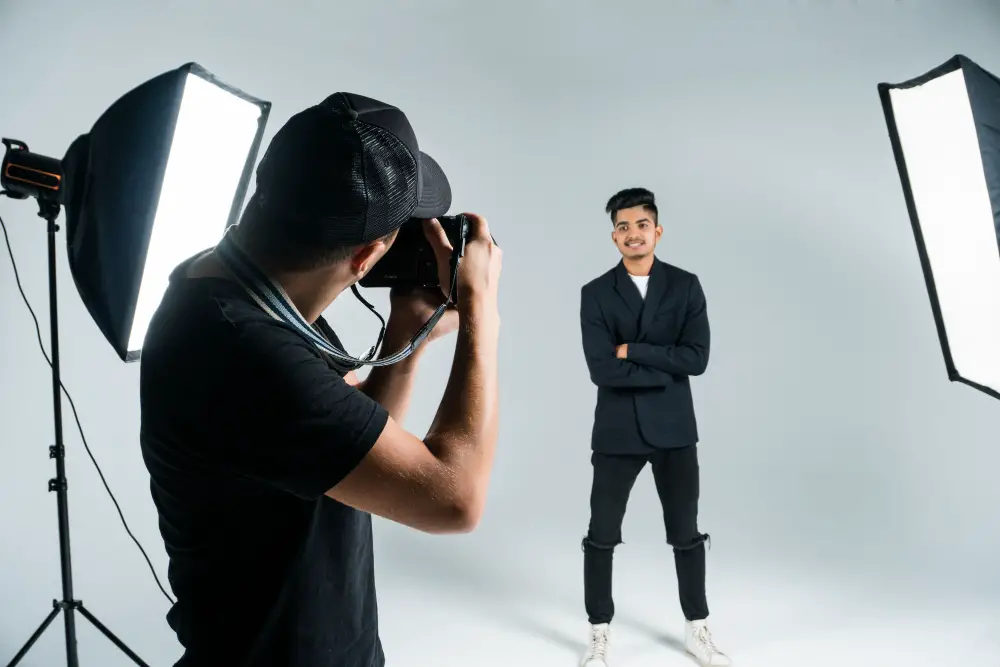 A smiling male college graduate poses in a studio for a professional LinkedIn profile picture