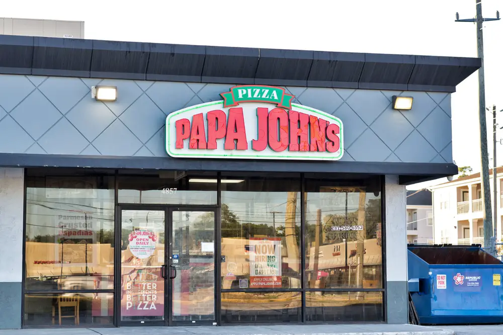 A Papa John's storefront during the day in Houston, Texas