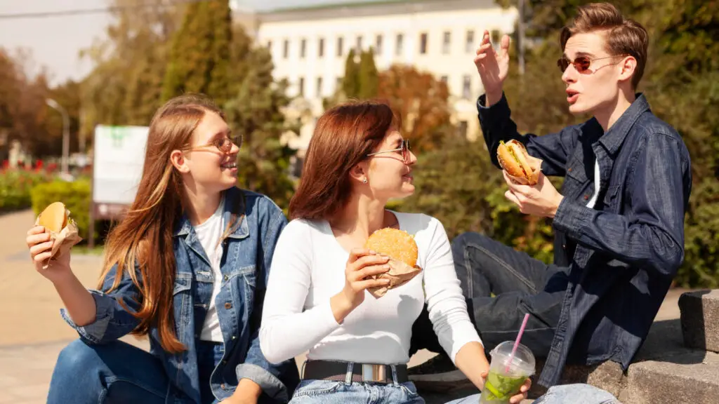 A group of friends enjoying the best college food outdoors the best college food