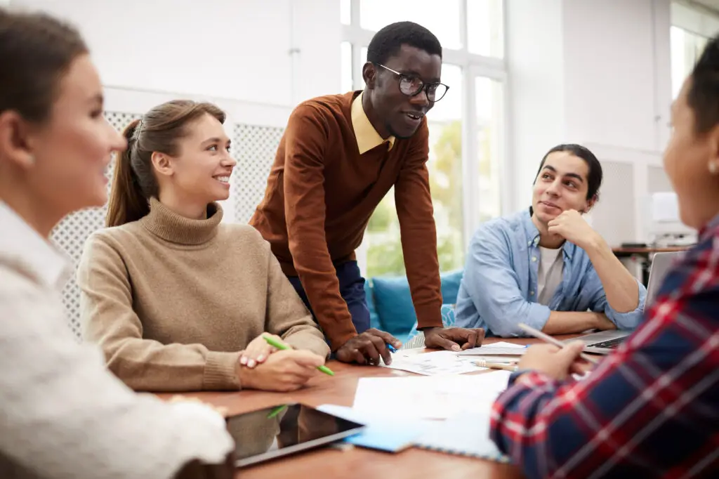 A diverse group of individuals sitting around a table engaged in a meeting or discussion for the BAR exam