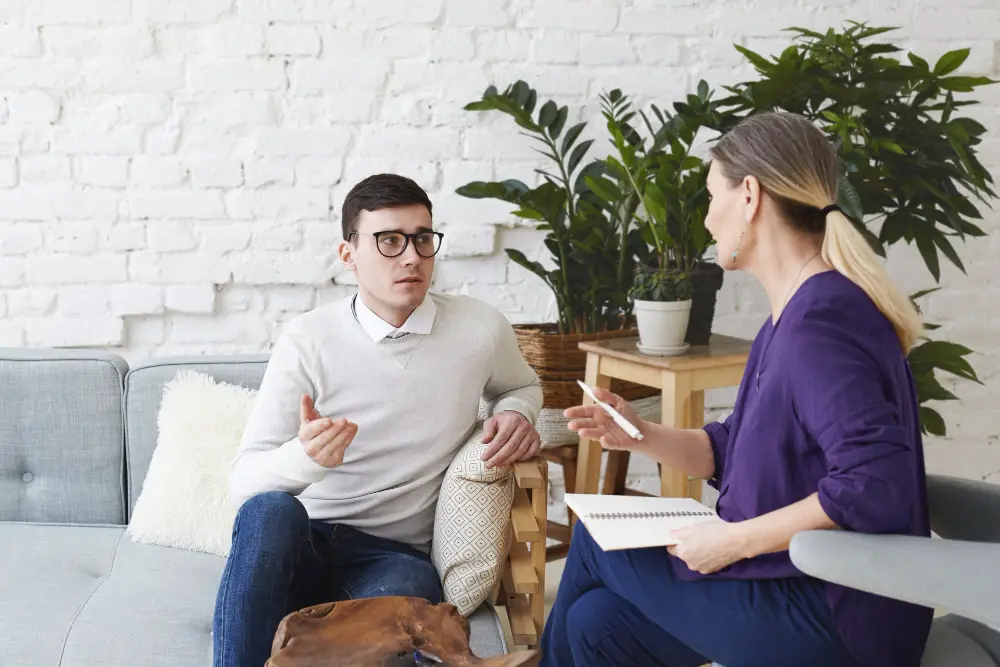 A male college student discusses his career questions with the female campus counselor during their session