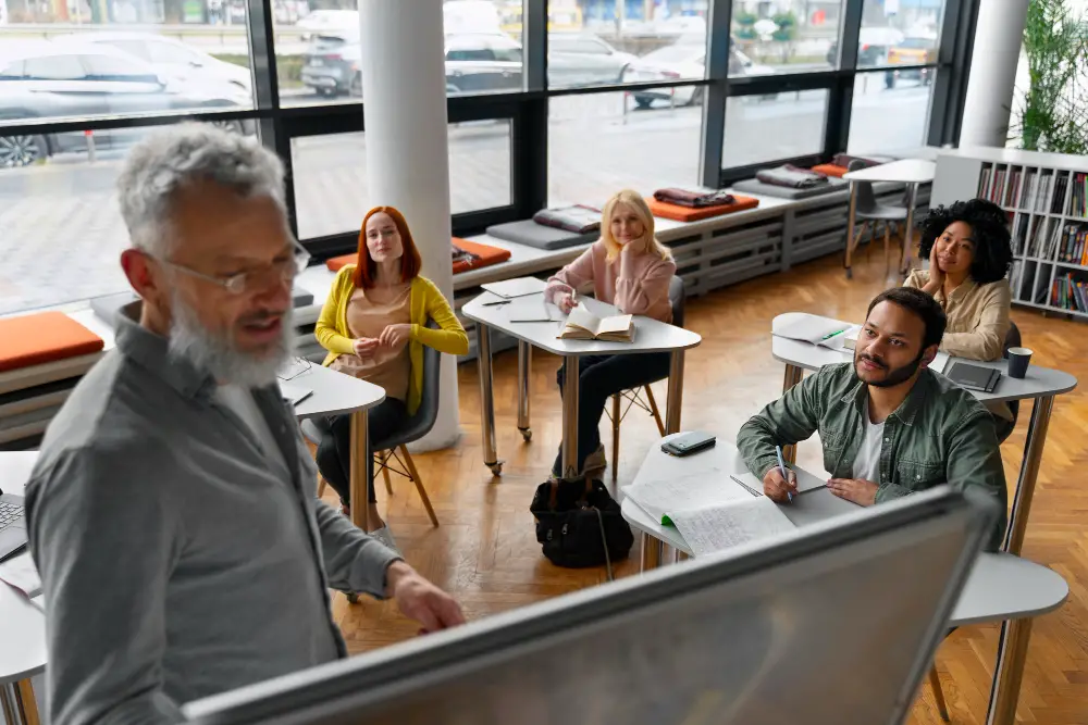 An old professor teaching a class of four diverse college students