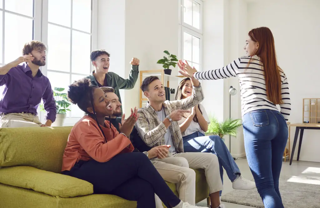 college students gathered on a sofa, engaged in an icebreaker activity