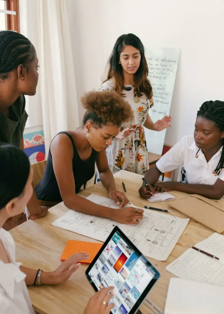 a diverse group of students working during their college internship program