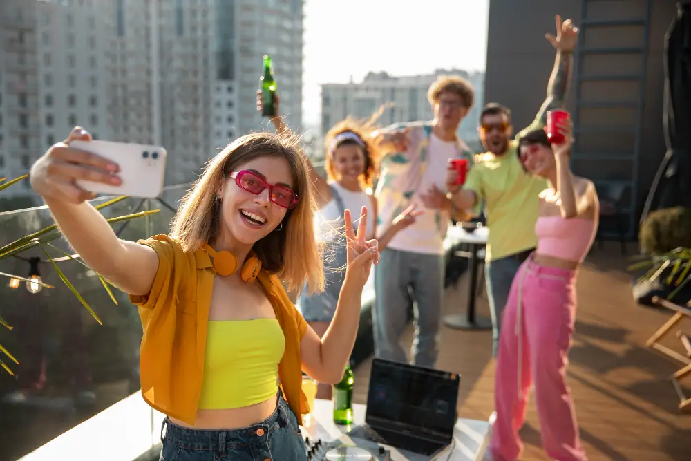 A co-ed Greek life society takes a group photo of themselves partying on a rooftop